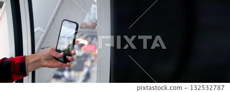 A captivating banner image capturing a woman engaged in tourism, actively taking pictures of a large Ferris wheel with her phone. tourism banner woman phone photography copy space A captivating banner image capturing a woman engaged in tourism, actively taking pictures of a large Ferris wheel with her phone. tourism banner woman phone photography copy space 132532787