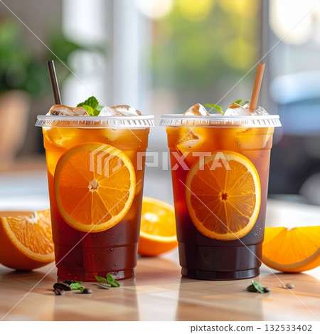 A glass of cold orange juice with ice A glass of cold orange juice with ice 132533402