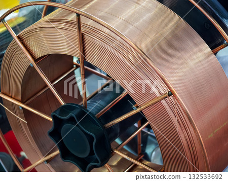 Copper wire spool displayed at a manufacturing facility for electrical components in the late afternoon Copper wire spool displayed at a manufacturing facility for electrical components in the late afternoon 132533692