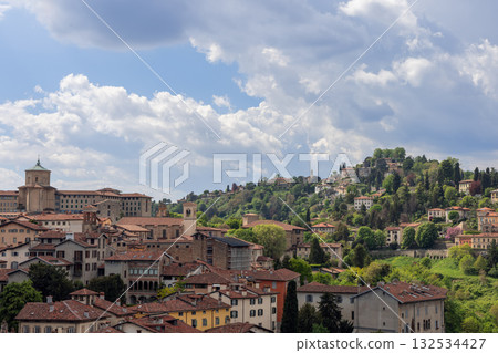Bergamo upper town panorama showing domed seminary, San Vigilio hill and castle ruins above villas Bergamo upper town panorama showing domed seminary, San Vigilio hill and castle ruins above villas 132534427