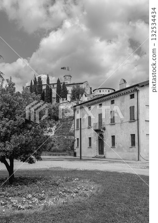 Brescia Castle in black and white showing Mirabella Tower rising above park under clouds Brescia Castle in black and white showing Mirabella Tower rising above park under clouds 132534434