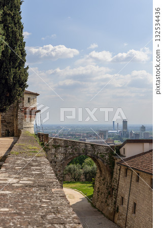 View from Castello di Brescia near Torre dei Prigionieri showing arched bridge and city skyline 132534436