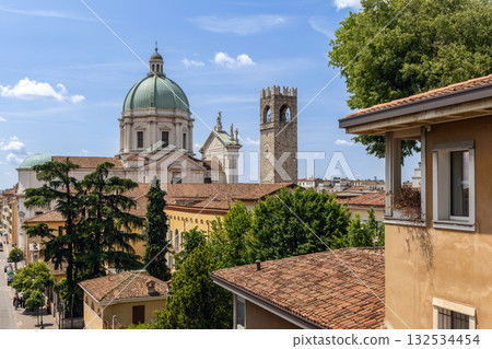Historic center of Brescia with Duomo Nuovo dome, stone bell tower, ochre buildings and cypresses Historic center of Brescia with Duomo Nuovo dome, stone bell tower, ochre buildings and cypresses 132534454