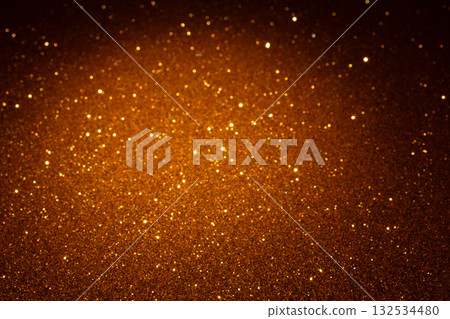 Golden glitter background with sparkling star-like highlights and glowing center fading into shadows 132534480