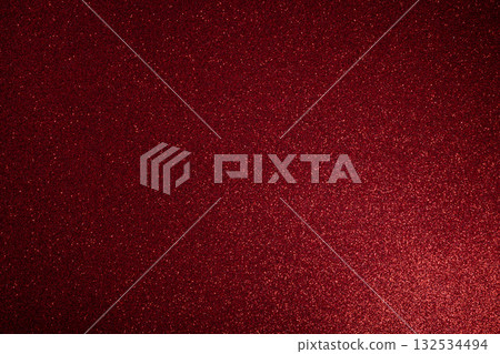 Deep red glitter surface glowing from lower right with macro focus on scattered sparkles 132534494