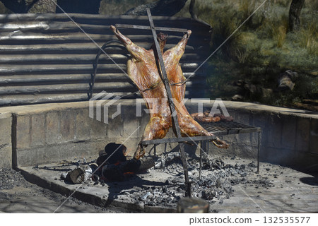 Lamb on the spit, cooked with the traditional Argentine method, La Pampa province, Patagonia, Argentina. Lamb on the spit, cooked with the traditional Argentine method, La Pampa province, Patagonia, Argentina. 132535577