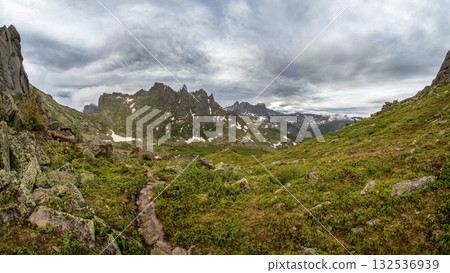 Hiking trail across the green stone plateau 132536939