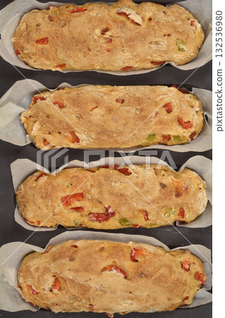 Freshly baked bread loaves with pieces of red Macedonian sweet pepper Freshly baked bread loaves with pieces of red Macedonian sweet pepper 132536980