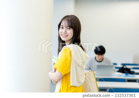 Female college student walking through the classroom Female college student walking through the classroom 132537301