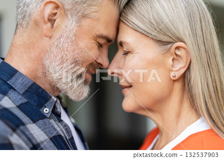 Waist up picture of man and woman face to face to each other feeling peaceful 132537903