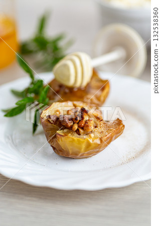 Traditional autumn dessert of apples filled with honey and nuts 132538360