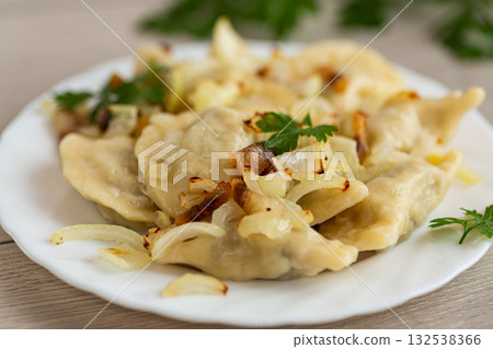 Ukrainian dumplings with potato filling and caramelized onions 132538366