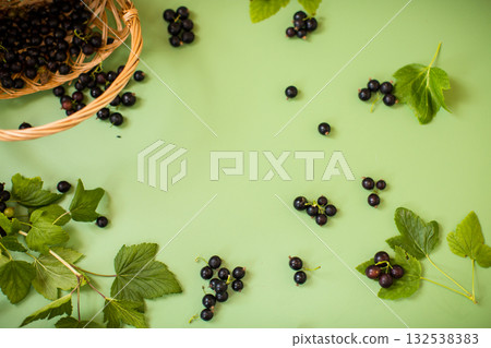 Summer fresh blackcurrants on a green background Summer fresh blackcurrants on a green background 132538383
