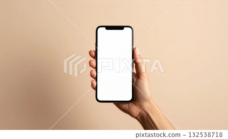 Woman's hand holding a smartphone and beige background 132538718