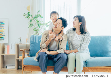 A family relaxing in the living room A family relaxing in the living room 132538801
