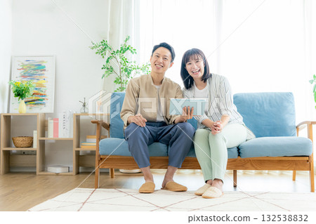 A couple looking at a tablet A couple looking at a tablet 132538832