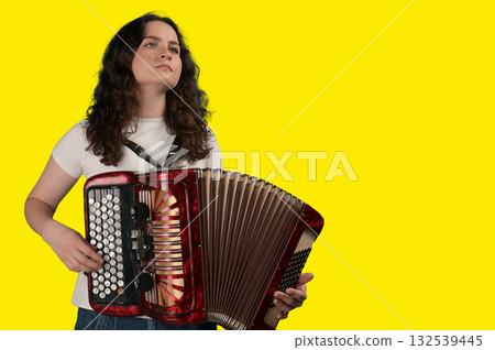 Young woman with a button accordion. Adult woman plays the button accordion 132539445