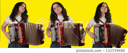 Young woman with a button accordion. Adult woman plays the button accordion 132539480