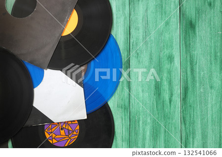 Vinyl record on a green background. Retro style. Top view. Vinyl record on a green background. Retro style. Top view. 132541066