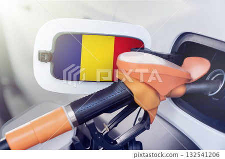 Romania flag on the lid of the gas tank of a car at a gas station in close-up. High or low prices for gasoline and diesel fuel at Romanian gas stations. fuel shortage for cars in Romania. 132541206