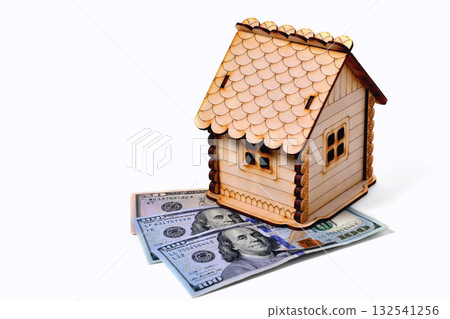 Wooden toy house, 2 banknotes 100 dollars 1 banknote 50 dollars on a white background, isolate, close up 132541256