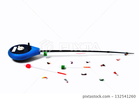 Fitted fishing rod for winter fishing and fishing spoon-bait on white background, close-up 132541260