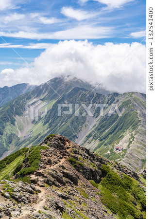 Aino-dake and its ridgeline, covered in a sea of clouds, seen from the summit of Kita-dake. Climbing Kita-dake in the Southern Alps Aino-dake and its ridgeline, covered in a sea of clouds, seen from the summit of Kita-dake. Climbing Kita-dake in the Southern Alps 132541400