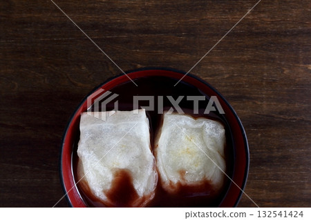 Oshiruko with grilled rice cakes on a table in the background, viewed from directly above Oshiruko with grilled rice cakes on a table in the background, viewed from directly above 132541424