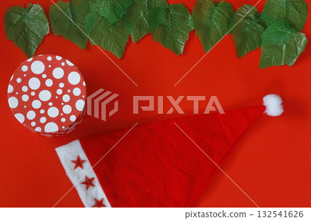 Christmas sparkling Santa Claus hat on red background. And gift box Christmas sparkling Santa Claus hat on red background. And gift box 132541626