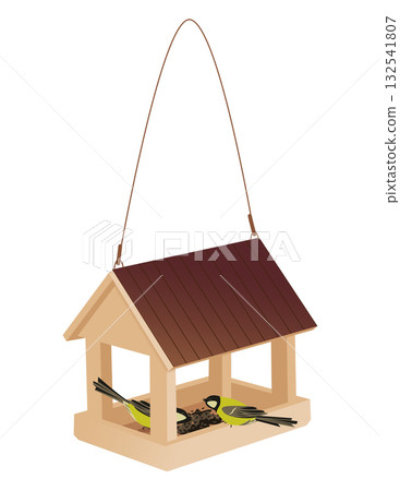 Tits eat food in a wooden feeder shaped like a house 132541807