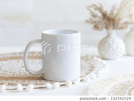 White blank coffee mug on boho placemat near pampas grass Close up, mockup for print on demand White blank coffee mug on boho placemat near pampas grass Close up, mockup for print on demand 132542529