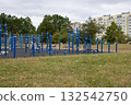 Open-air city sports ground with outdoor exercise equipment. Sports complex in a residential area. 132542750