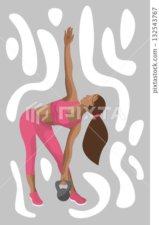 A fitness woman performs a side stretch while holding a kettlebell, showcasing her dedication to health and wellness in a modern indoor setting. 132543767