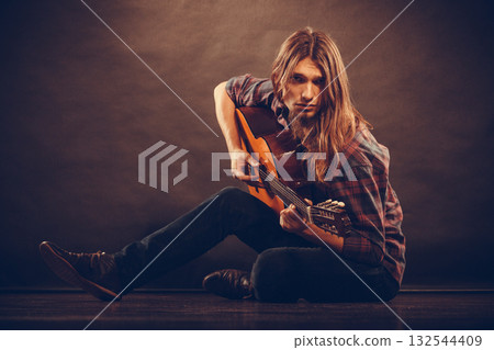 Romantic young man with guitar. 132544409