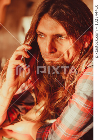 Worried man talking on mobile phone. Worried man talking on mobile phone. 132544410