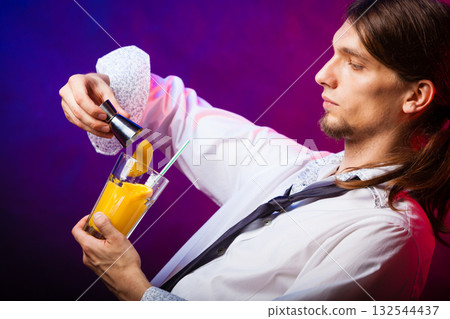 Young man bartender preparing alcohol cocktail drink Young man bartender preparing alcohol cocktail drink 132544437