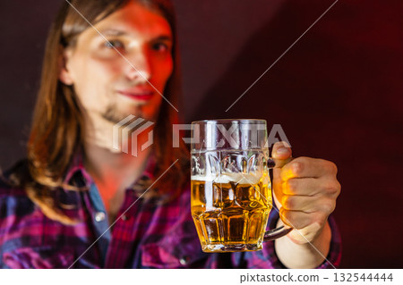 Young man drinking pint. 132544444