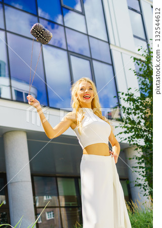 Cheerful fashionable woman in city 132544612