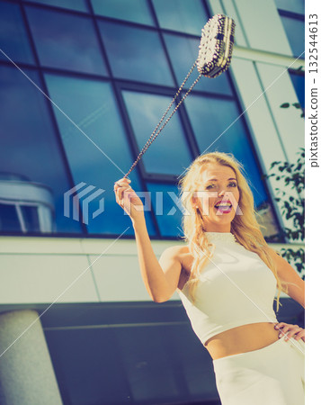 Cheerful fashionable woman in city Cheerful fashionable woman in city 132544613