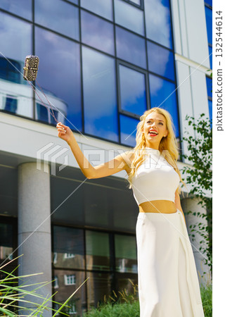 Cheerful fashionable woman in city Cheerful fashionable woman in city 132544614