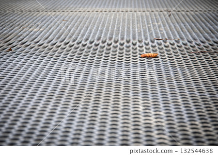 Close up of industrial metal floor covering with strong geometric grid pattern and textured steel Close up of industrial metal floor covering with strong geometric grid pattern and textured steel 132544638