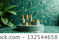 Luxurious skincare set in elegant green and gold packaging on matching tray, set against decorative emerald tiles. Perfect for promoting premium cosmetics, spa products, or self-care collections 132544658