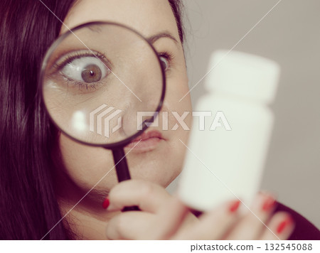 Woman investigating ingredients of medicines 132545088
