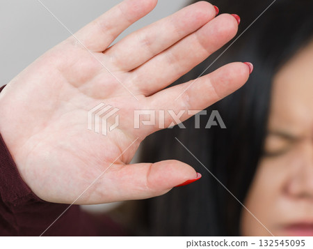Woman showing stop hand sign gesture. Woman showing stop hand sign gesture. 132545095