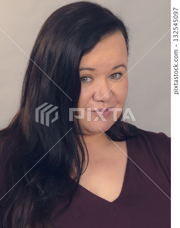 Potrait of plus size woman with dark hair 132545097