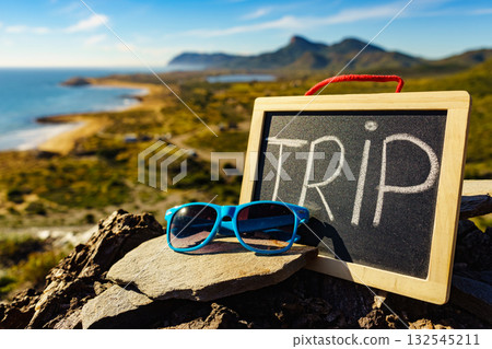 Black board with word trip against sea coast 132545211