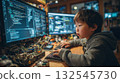 Young asian boy engrossed in coding at home, child surrounded by multiple computer screens and electronic components 132545730