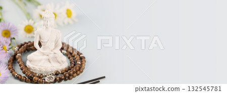 Buddha statue, prayer beads, aroma sticks and wild flowers on light background with copy space. Healing and meditation, Energetic health and relax. Vesak, Buddha Day. Soft image style 132545781