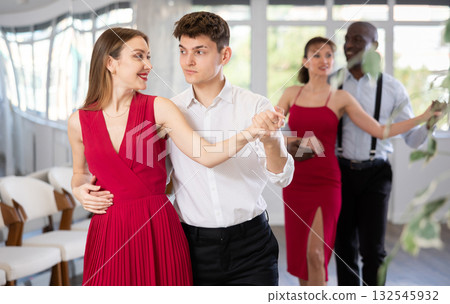 Young guy and young woman dance waltz 132545932