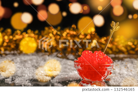 Red caviar in glass bowl with golden spoon on festive background, luxury seafood delicacy served with sparkling holiday lights and golden bokeh, Christmas and New Year celebration concept Red caviar in glass bowl with golden spoon on festive background, luxury seafood delicacy served with sparkling holiday lights and golden bokeh, Christmas and New Year celebration concept 132546165